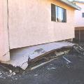 Garage door crushed after complete soft-story collapse in Northridge earthquake.