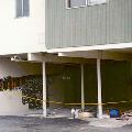 Parking lot under apartment complex showing damage to outer wall